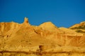 Natural sandstone formations: formed from cemented sand grains, yellow-orange in colour, forming rough cliffs against bright blue Royalty Free Stock Photo